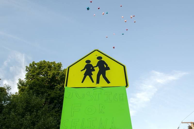 Balloons float over a sign asking for justice in the death of Celina Serrano Wednesday, June 1, 2022 during the vigil.