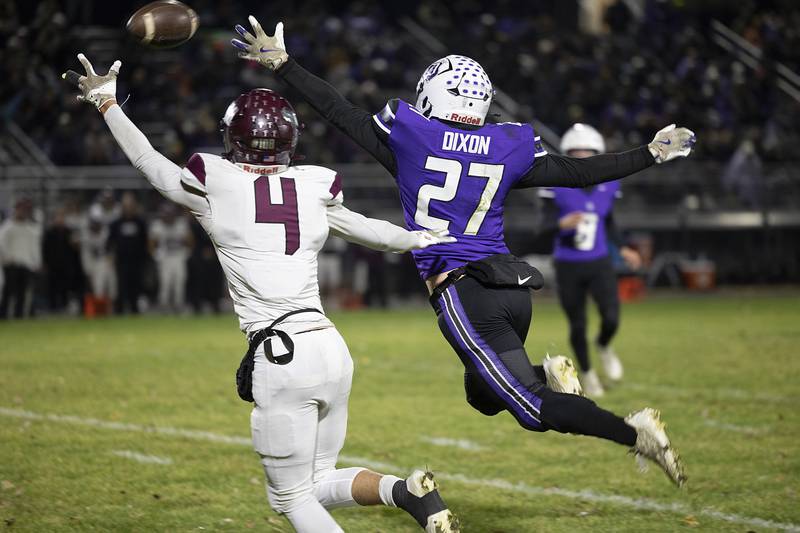 Marengo’s Parker Mandelky defends Dixon’s Eli Davidson on a pass Friday, Nov. 1, 2024 in the 4A football playoffs in Dixon.
