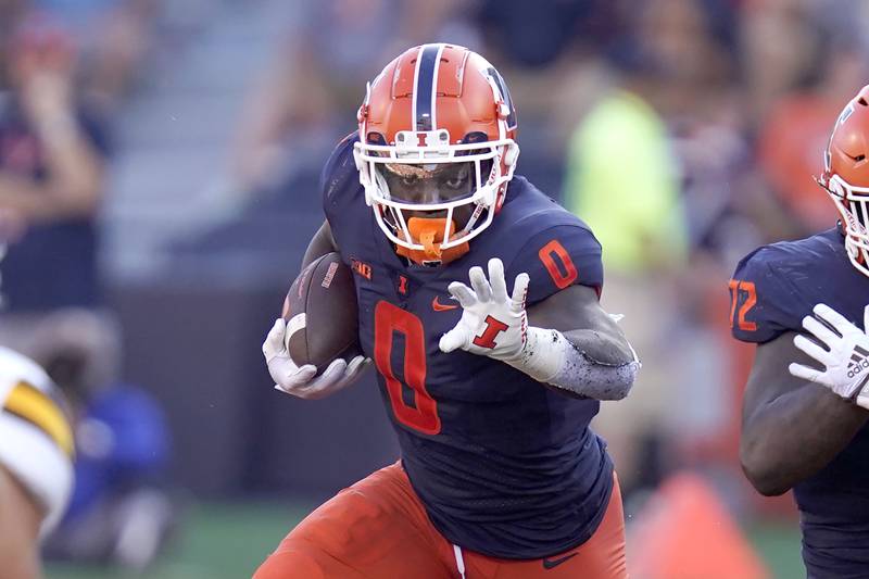Illinois running back Josh McCray carries the ball during an NCAA college football game, Sunday, Aug. 28, 2022, in Champaign, Ill. (AP Photo/Charles Rex Arbogast)