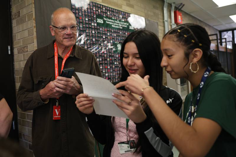 Larry Nielson, a former student from Grompers Junior High School, left, along with Alisson Gaitan Lopez and Isabella Salgado read a letter found in a time capsule on Wednesday, May 1, 2026 in Joliet. In 1969 students placed items in a time capsule and sealed it inside a wall when an extension was built at Grompers Junior High School.