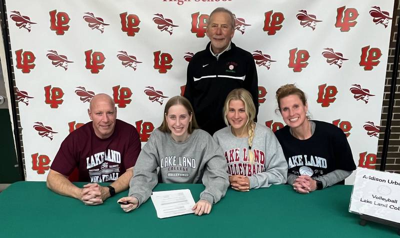 La Salle-Peru senior Addison Urbanski (seated, second from left) signs to play volleyball at Land Land College. She was joined by (seated from left), her father, Mike, her sister, Ashley, and her mother Laura along with L-P coach Mark Haberkorn.