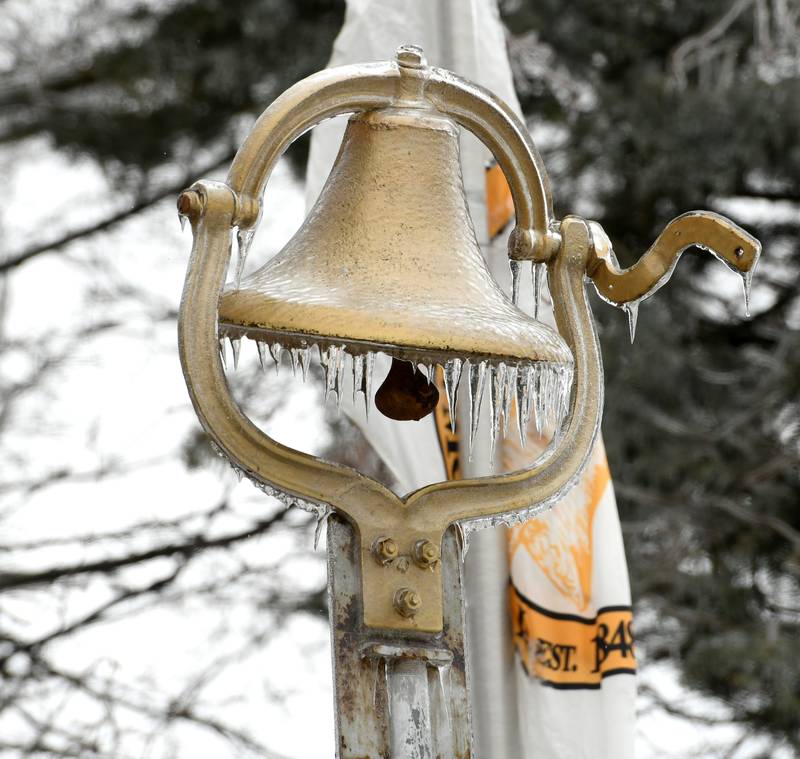 Ice covers the bell by the American Legion memorial in downtown Mt. Morris on Thursday. Freezing rain fell across portions of Ogle County making travel hazardous for motorists and prompting cancellations of evening events.