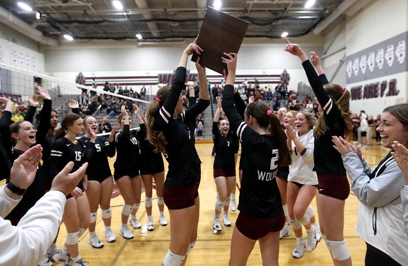 Prairie Ridge's Abby Smith and Abby Smith raise the trophy after defeating Crystal Lake South in the IHSA Class 3A Prairie Ridge Regional championship volleyball match on Thursday, Oct. 30, 2025, at the Prairie Ridge High School in Crystal Lake.