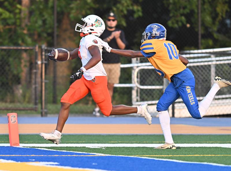 Plainfield East's David Croom (6) outruns Joliet Central's Roiatti Botendu (10) for a touchdown during the conference game on Friday, SEP. 12, 2025, at Joliet.