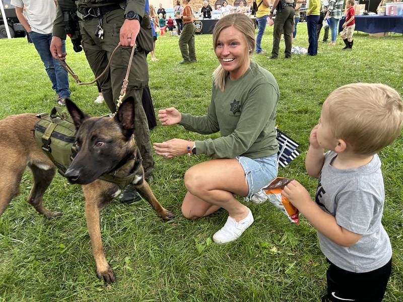 Logan Gendusa, 2, and his mom, Lindsey, of Byron, visit with Gator, one of the Ogle County Sheriff Department's K-9s during National Night Out in Byron on Tuesday, Aug. 6, 2024. The event was held in partnership with the Byron fire and police departments.