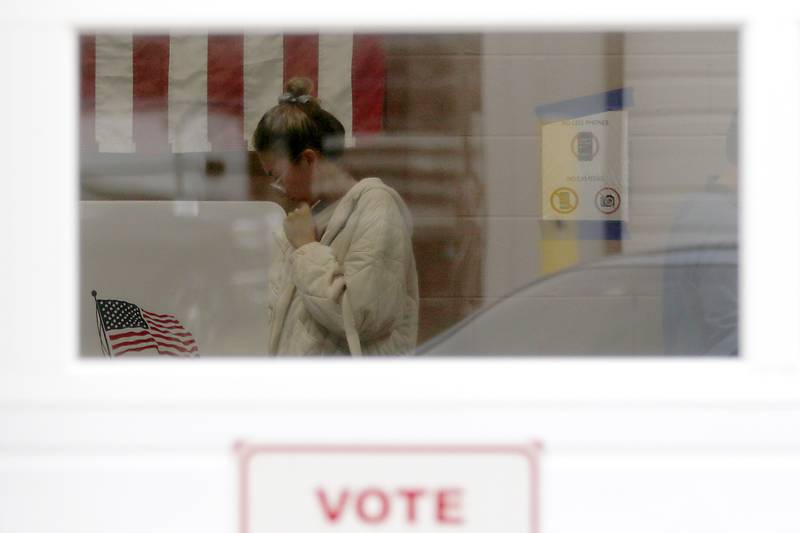 A woman votes on Monday, Nov. 4, 2024, at the Algonquin Township Office at 3702 US Hwy 14, in Crystal Lake.