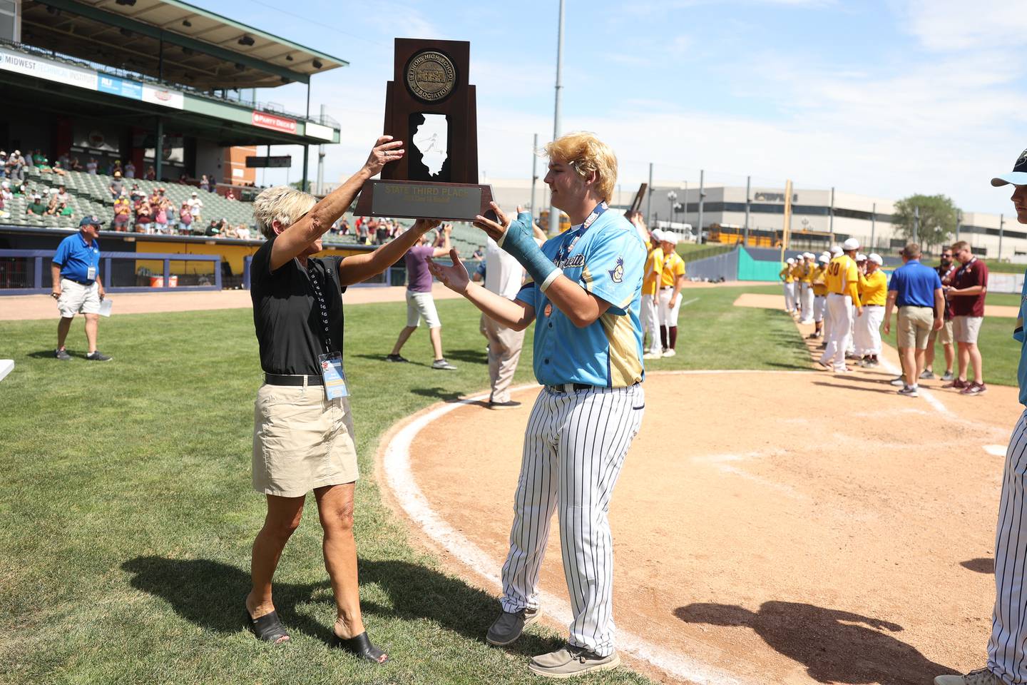 Marquette’s Brady Ewers receives the 3rd place trophy after the Crusaders 12-0 win over Leroy in the IHSA Class 1A 3rd place game. Saturday, June 4, 2022 in Peoria.