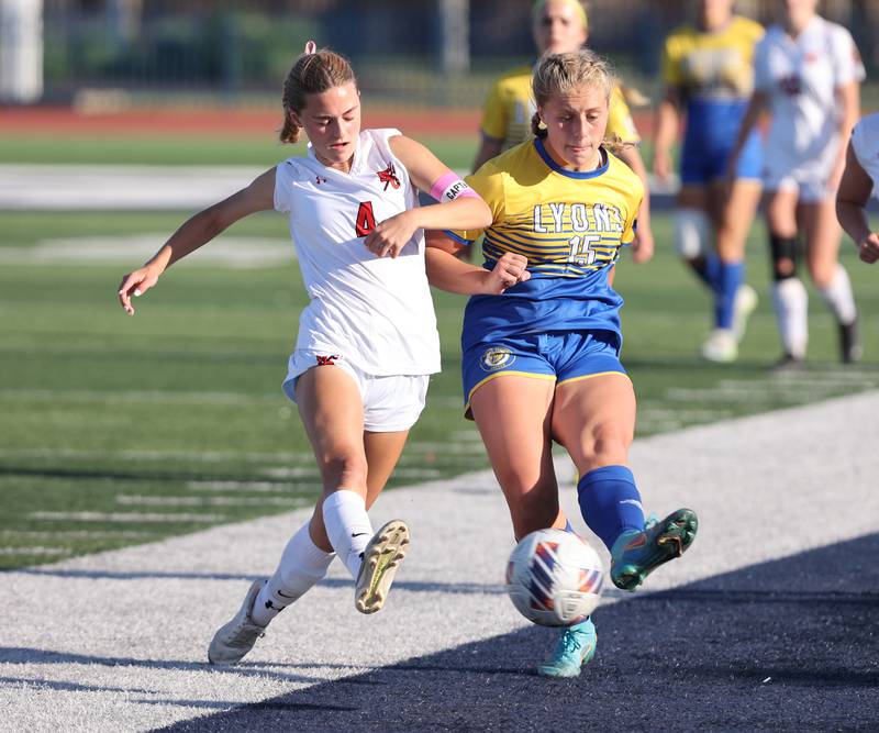Lyons Township's Zibby Michaelson (15) and Hinsdale Central's Carter Knotts (4) go for the ball during the IHSA Class 3A girls soccer sectional final match between Lyons Township and Hinsdale Central at Reavis High School in Bubank on Friday, May 26, 2023.