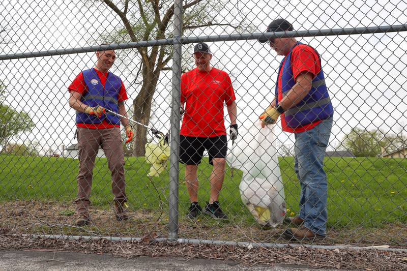 Volunteers Zachary Weidner, left, Todd Robinson, center, and Craig Gaus, with Dow Chemical in Kankakee, clean up Washington Park during the United Way of Kankakee & Iroquois Counties’ annual Day of Action on Wednesday, April 22, 2026.
