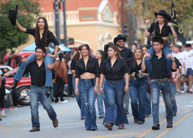 One of the many Northern Illinois University student organizations march in the parade Thursday, Oct. 2, 2025, during the Huskie Homecoming Block Party in downtown DeKalb.