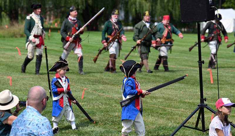 From left to right, watching the battle occur are Andrew Nan, 4, and MJ Nan, 7, from Barrington at Cantigny Park in Wheaton on Sept. 8, 2024. The boys’ mother Kate Smith said about the siblings, “They’re really into history so we watch a lot of documentaries and the Civil War and Revolutionary War are their favorites.”