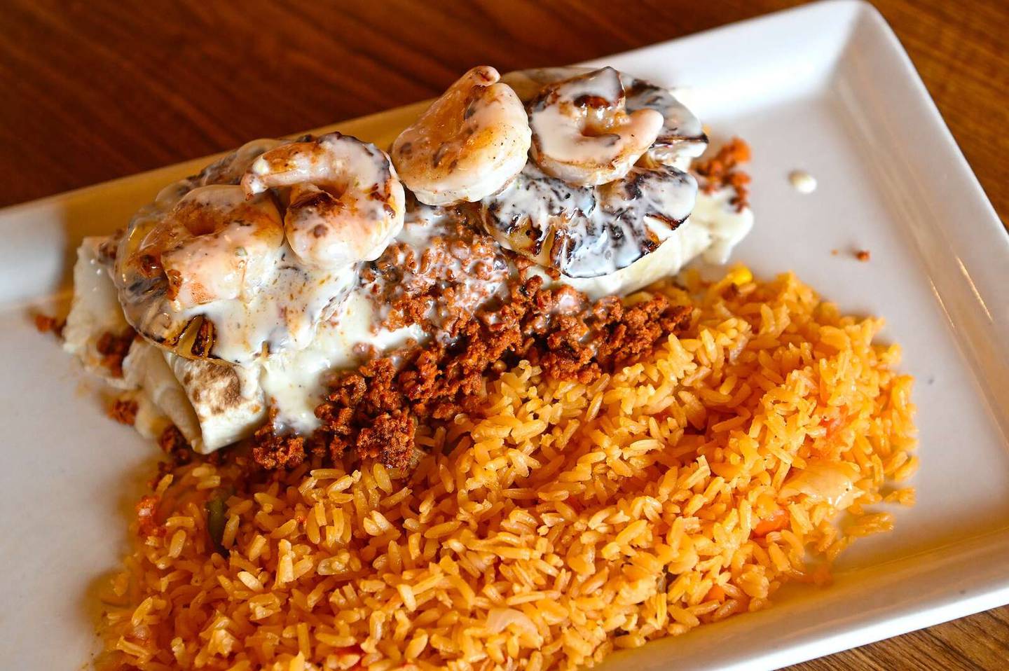 Luigi’s Burrito at Casa Tequilas is filled with grilled chicken and steak and topped with shrimp, chorizo, grilled pineapple and cheese dip.