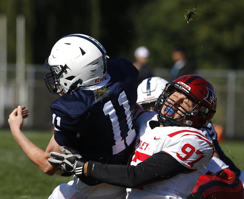 Huntley's Mason Maldonado tackles Cary-Grove's Peyton Seaburg during a Fox Valley Conference  football game on Saturday, Oct. 7, 2023, at Cary-Grove High School.
