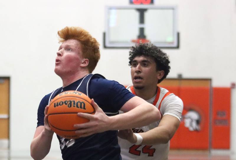 Cary-Grove’s Jack Berndt, left, gets past McHenry’s Adam Anwar in varsity boys basketball on Tuesday, Feb. 17, 2026, at McHenry High School in McHenry.