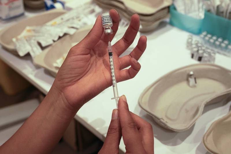 A medical staff prepares a syringe with the a Pfizer COVID-19 vaccine at a shopping mall in Paris, Tuesday, July 13, 2021. More than 1 million people in France made vaccine appointments in less than a day after the president cranked up pressure on everyone to get vaccinated to save summer vacation and the French economy. (AP Photo/Michel Euler)