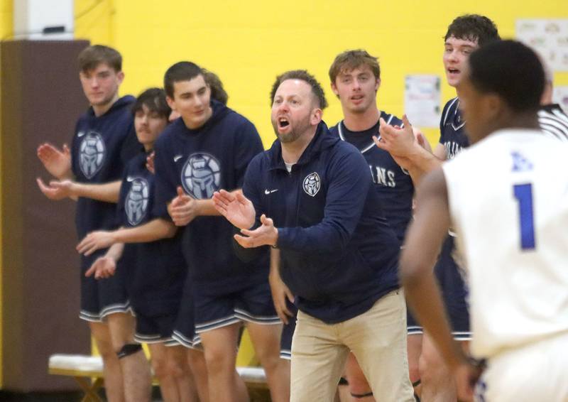 Cary-Grove’s Head Coach Adam McCloud and players react as the Trojans build a first-half lead against Larkin in varsity boys basketball Hinkle Holiday Classic action on Friday, Dec. 26, 2025, at Jacobs High School in Algonquin.