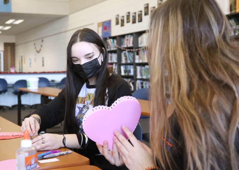 Genoa-Kingston High School sophomore  Maddy Schroeder makes a Valentines Day card Tuesday, Jan. 25, 2022, in the library at the school. The cards students are making will be part of “Valentines for Seniors,” a card drive for local seniors living in residential care facilities, sponsored by State Representative Jeff Keicher, R-Sycamore, and State Senator Dave Syverson R-Rockford.