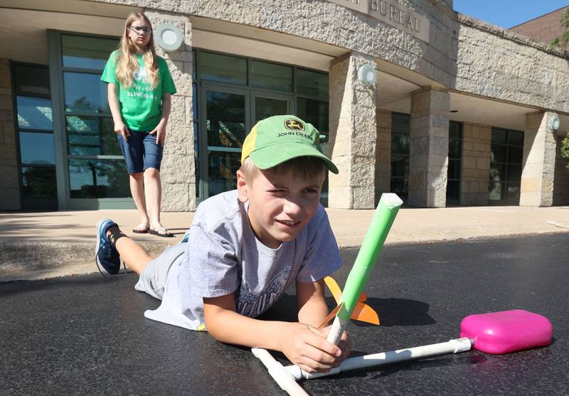Samuel Hetland, 11, from Clare, aims his rocket, as his sister Lillian, 14, looks on during the 4-H General Project Show Thursday, July 14, 2022, at the DeKalb County Farm Bureau in Sycamore.