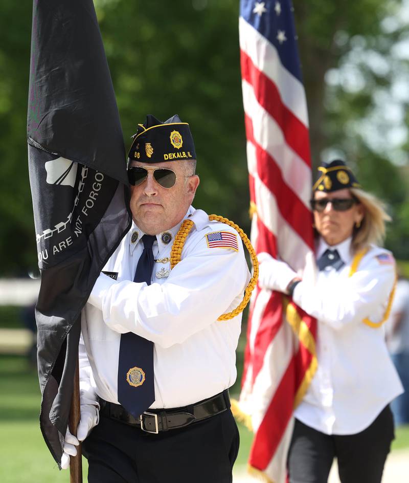 Members of the DeKalb American Legion Post 66 Honor Guard remove the flags Monday, May 26, 2025, following the Memorial Day ceremony at Ellwood House in DeKalb.