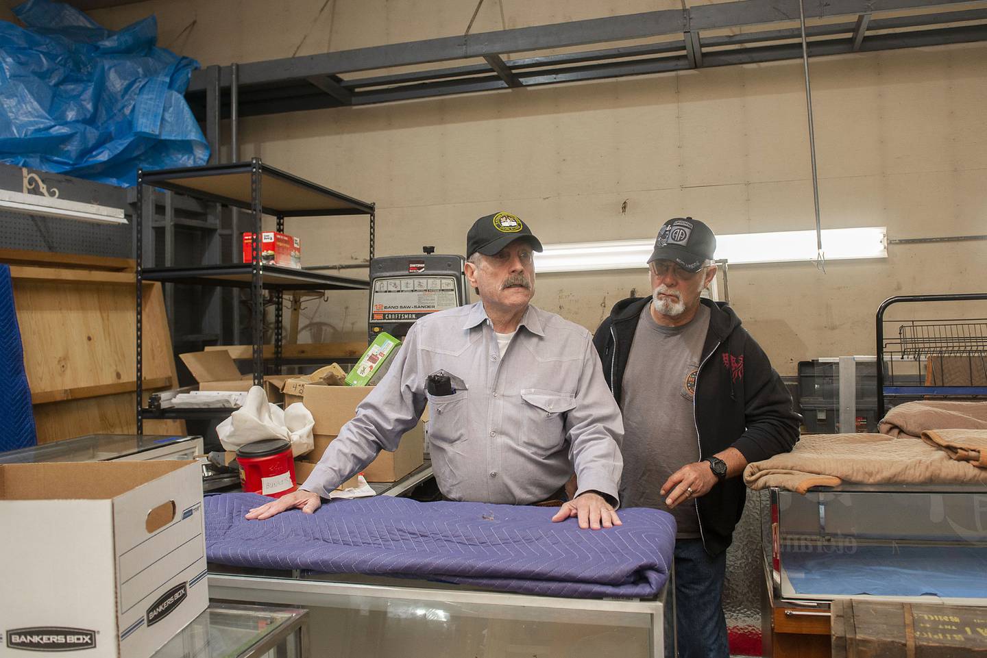 Dixon Veterans Park board members Keane Hudson (left) and Mike Jordan stand with display cases that will be used in the new veterans museum in Dixon. The board bought a former auto shop next to the park and is moving towards renovating the facility to be used to showcase their mementos and artifacts.