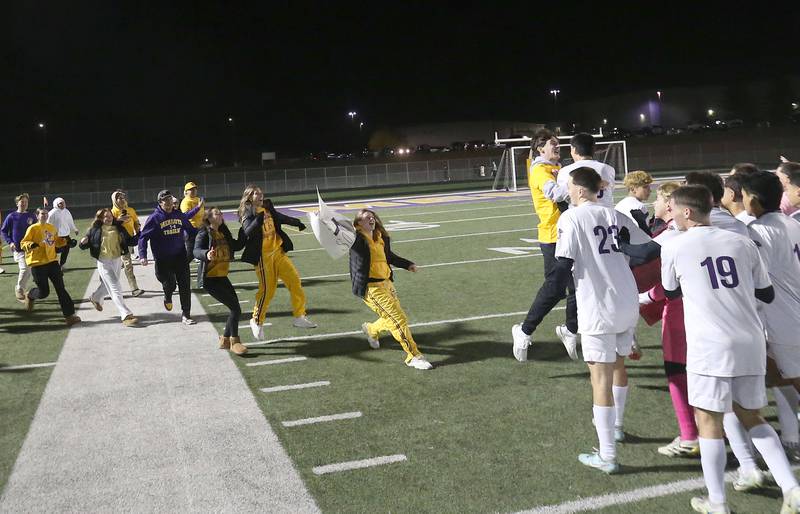 Mendota students rush the field to congratulate the boys soccer team after defeating Quincy Notre Dame during the Class 1A Supersectional game on Monday, Nov. 3, 2025 at Mendota High School.
