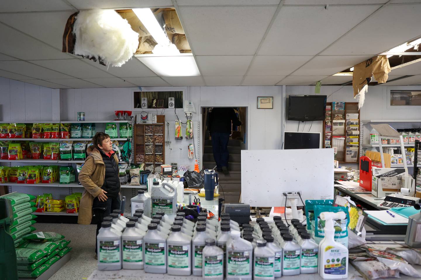 Nancy Tholen pauses to observe the damage at Tholens' Landscape & Garden Center along South Schuyler Avenue in Kankakee on March 13, 2026, following the March 10 tornado that caused widespread destruction in Kankakee County.