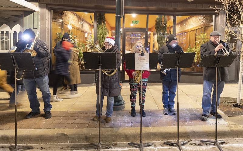 Members of the Dixon Municipal Band plays some classic Christmas tunes Friday, Dec. 6, 2024, in the downtown.