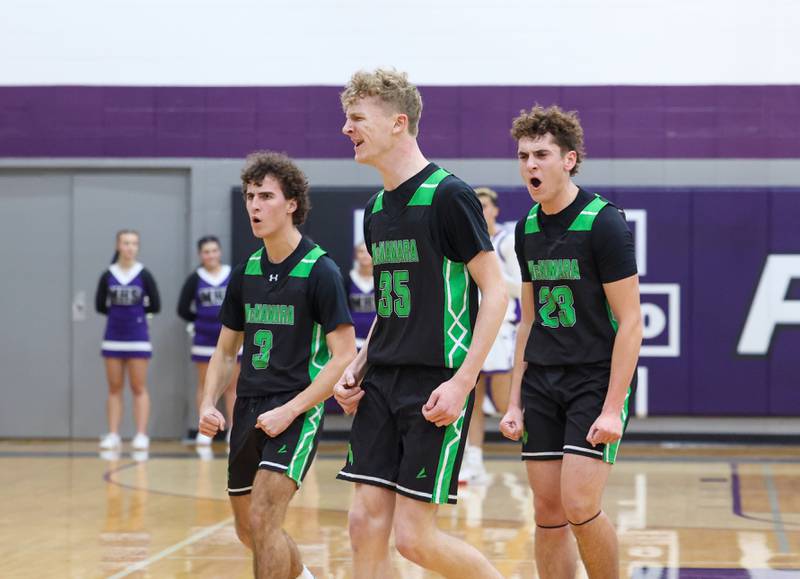 Bishop McNamara's Richard Darr, center, Prestone Payne, left and Karter Krutsinger celebrate their lead as a timeout is called during the Fightin' Irish's 61-24 victory over Manteno on Tuesday, Jan. 13, 2026.