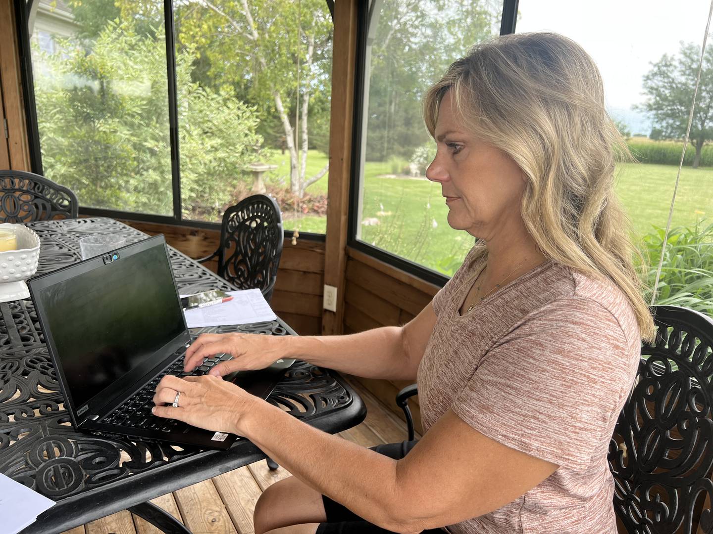 Mollie Hughes, CEO and co-founder of Softly works from a gazebo in her backyard in Genoa on Friday, Aug. 12, 2022.