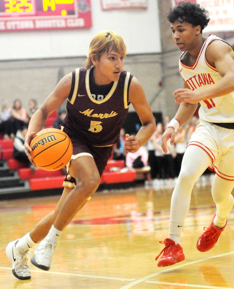 Morris senior Luis Loza (5) tries to dribble past Ottawa senior Hezekiah Joachim on Friday, Dec. 12, 2025 at Kingman Gym.