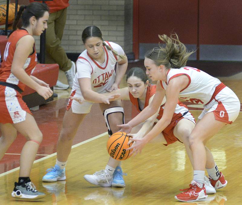 Ottawa’s Marlie Orlandi and Ashlynn Ganiere battle Streator’s Isabel Guttierz Audrey Arambula for a loose ball in the 2nd period Thursday at Ottawa.