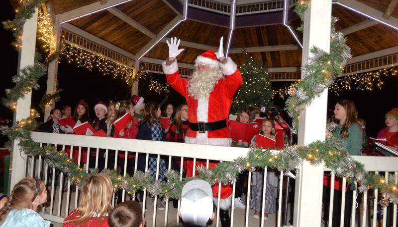 Santa Claus raises his hands and with help from the crowd the Christmas tree in gazebo was lit to start the Port Byron Christmas Walk on Friday, Dec. 8, 2023.