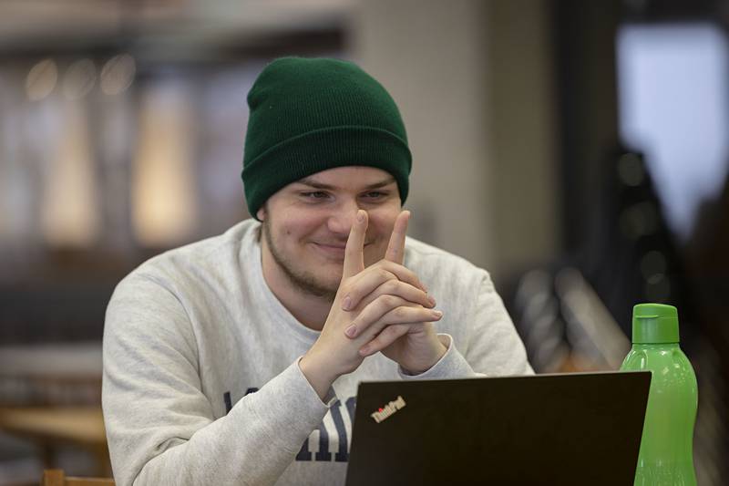 Holden Longan of Dixon concentrates on his fingers during a power of suggestion stunt performed by Christopher Carter Wednesday, Nov. 6, 2022 at Sauk Valley Community College.