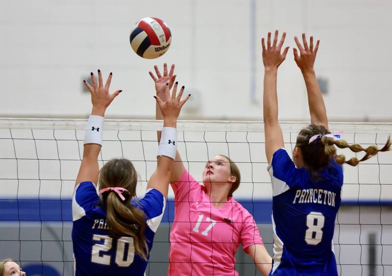 Hall's Caroline Morris takes a hit over Princeton's Ellie Harp (20) and Keighley Davis Thursday at Prouty Gym.