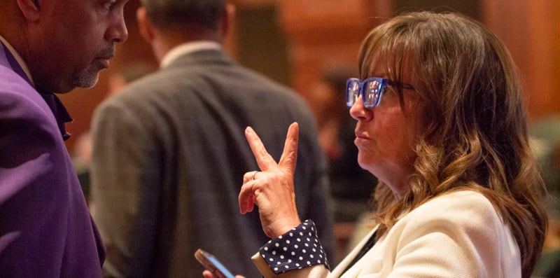 State Rep. Katie Stuart, D-Edwardsville, speaks to chief of staff Clayton Harris shortly after passing a bill that mandates employers give nursing mothers paid time to pump breast milk.