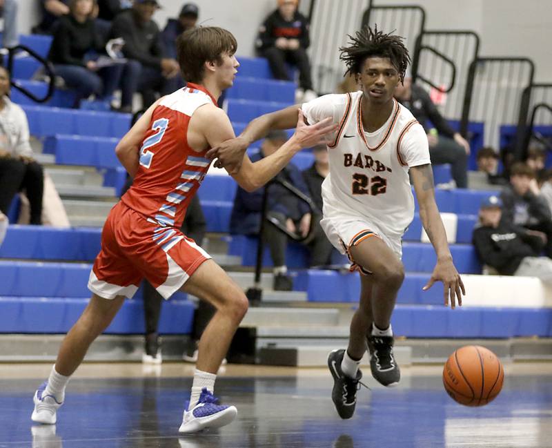 DeKalb's Darell Island pushes the ball up the court against Marian Central's Jake Giangrego during a Central High School’s Dr. Martin Luther King, Jr., Boys Basketball Tournament game Friday, Jan. 13, 2023, at Central High School in Burlington.