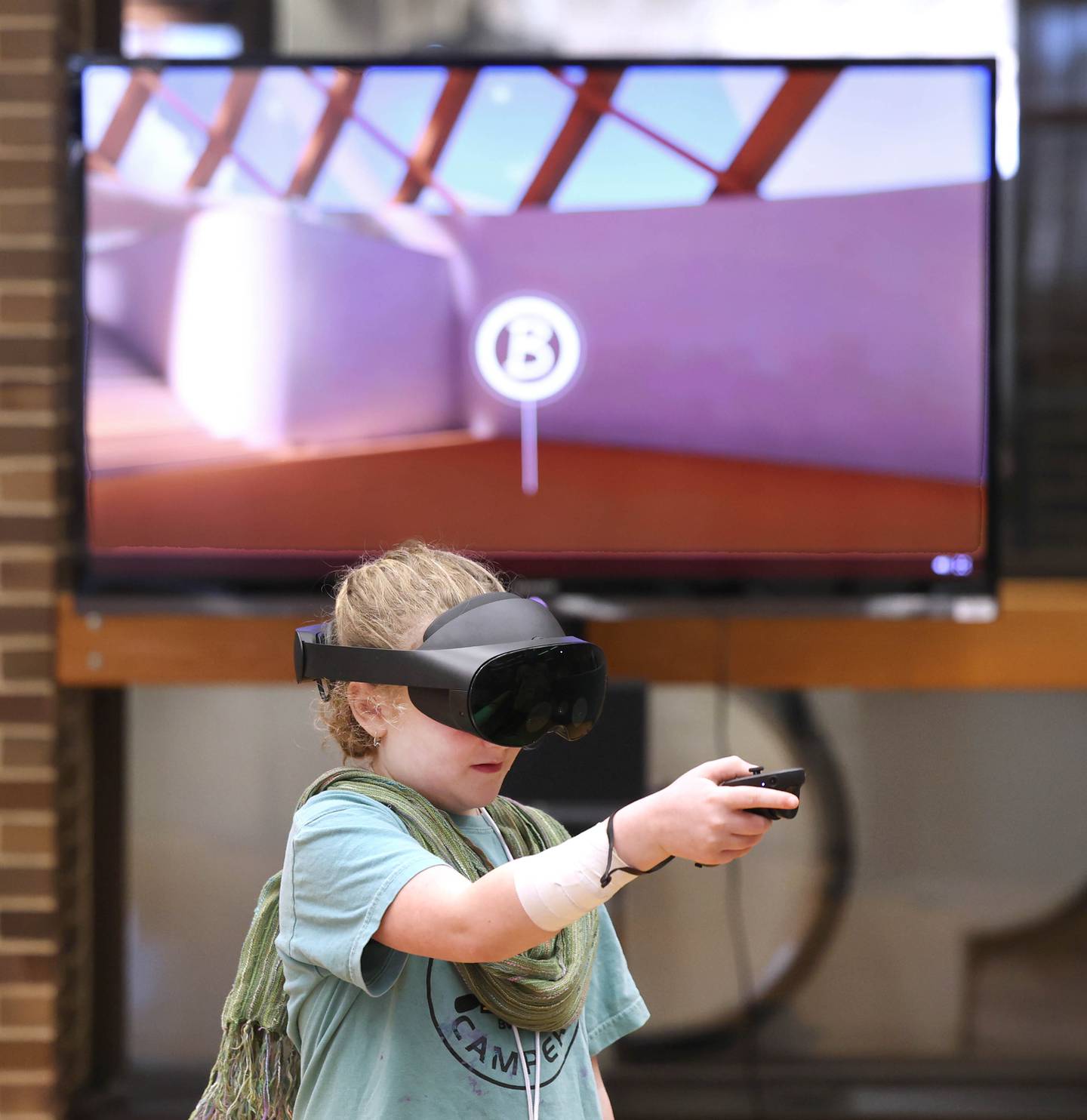 Ellie Langley, 8, from DeKalb, checks out the virtual reality exhibit Saturday, April 5, 2025, during Earth Fest in Founders Memorial Library at Northern Illinois University in DeKalb.