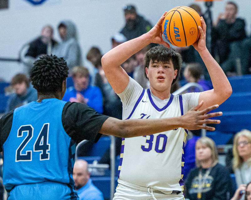 Cash Raikes (30) of Serena holds ball over head whilst being guarded by IMSA's Omar Njikam in the quarterfinals of the Little Ten Conference Tournament on Monday, Feb. 2, 2026 at Somonauk High School in Somonauk.