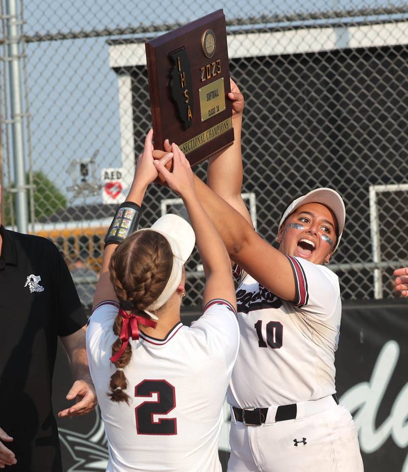 Antioch's Aubrey Ultsch (left) and Syerra Gilmore hoist the Class 3A supersectional trophy after their win over Sycamore Monday, June 5, 2023, at Kaneland High School in Maple Park.