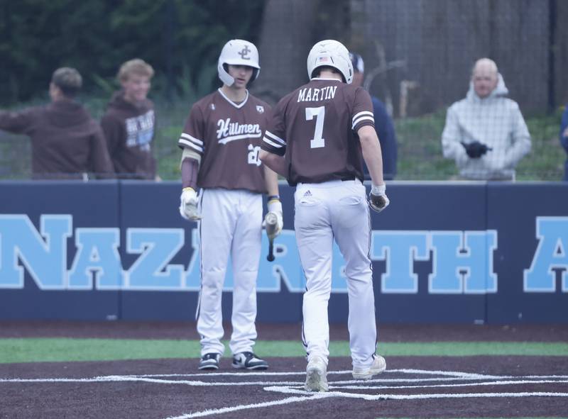 Joliet Catholic's Steve Martin (7) scores on a balk during the varsity baseball game on Wednesday, April 20, 2025 between Nazareth and Joliet Catholic academies in La Grange Park.