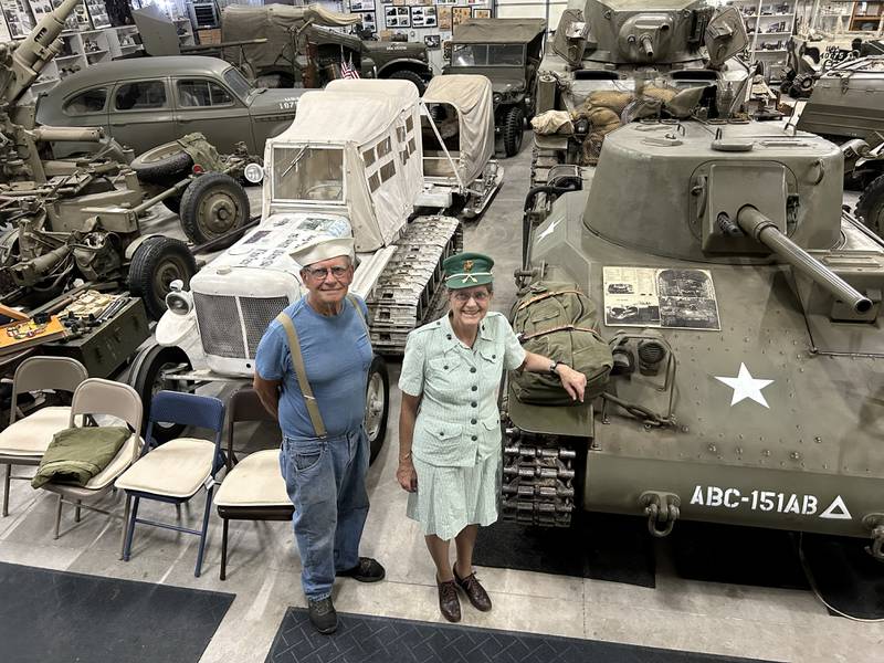 Charles and Lydia Roberts stand among their many WWII vehicles at Roberts Armory, a WWII historical museum near Rochelle. The museum also features other memorabilia and items from the era.