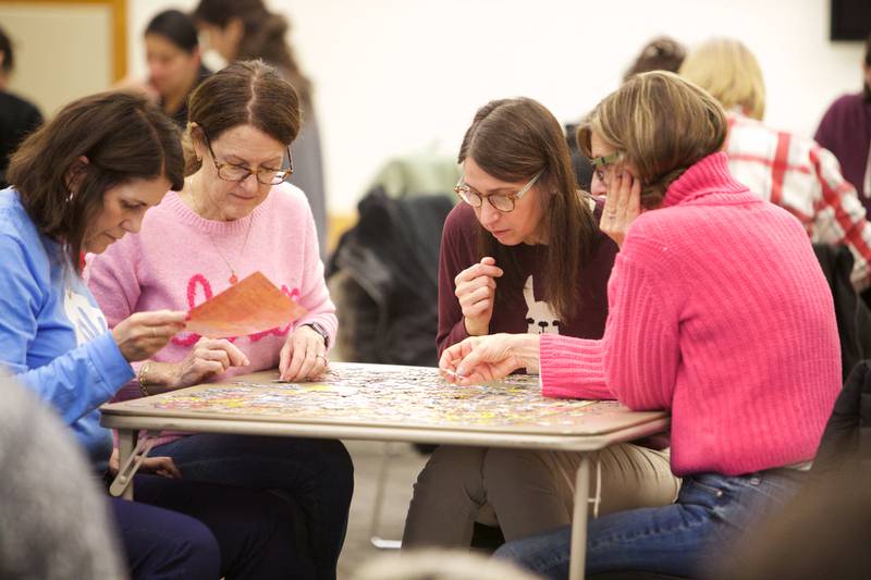 Teams compete in a 500 piece puzzle speed race competition on Saturday, Jan. 27,2024 at the Elmhurst Library in Elmhurst.