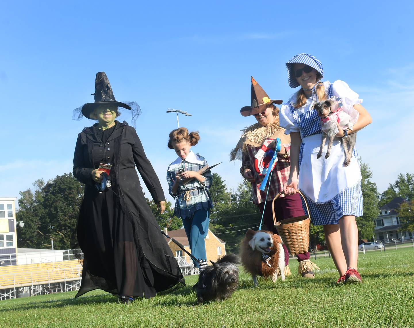 The Joines family took the Best Overall Award at the Polo High School's Student Council's Doggy Dash Costume Contest with their Wizard of Oz themed attire. Pictured here, left to right, are Wicked Witch Paula Joines and Annie as Toto; Munchkin Amelia Manis; Scarecrow Beth Manus and Ginger as the Cowardly Lion; and Dorothy Emily Joines and Eden as Glenda the Good Witch. Emily is a teacher at the high school and one of the organizers of this year's event.