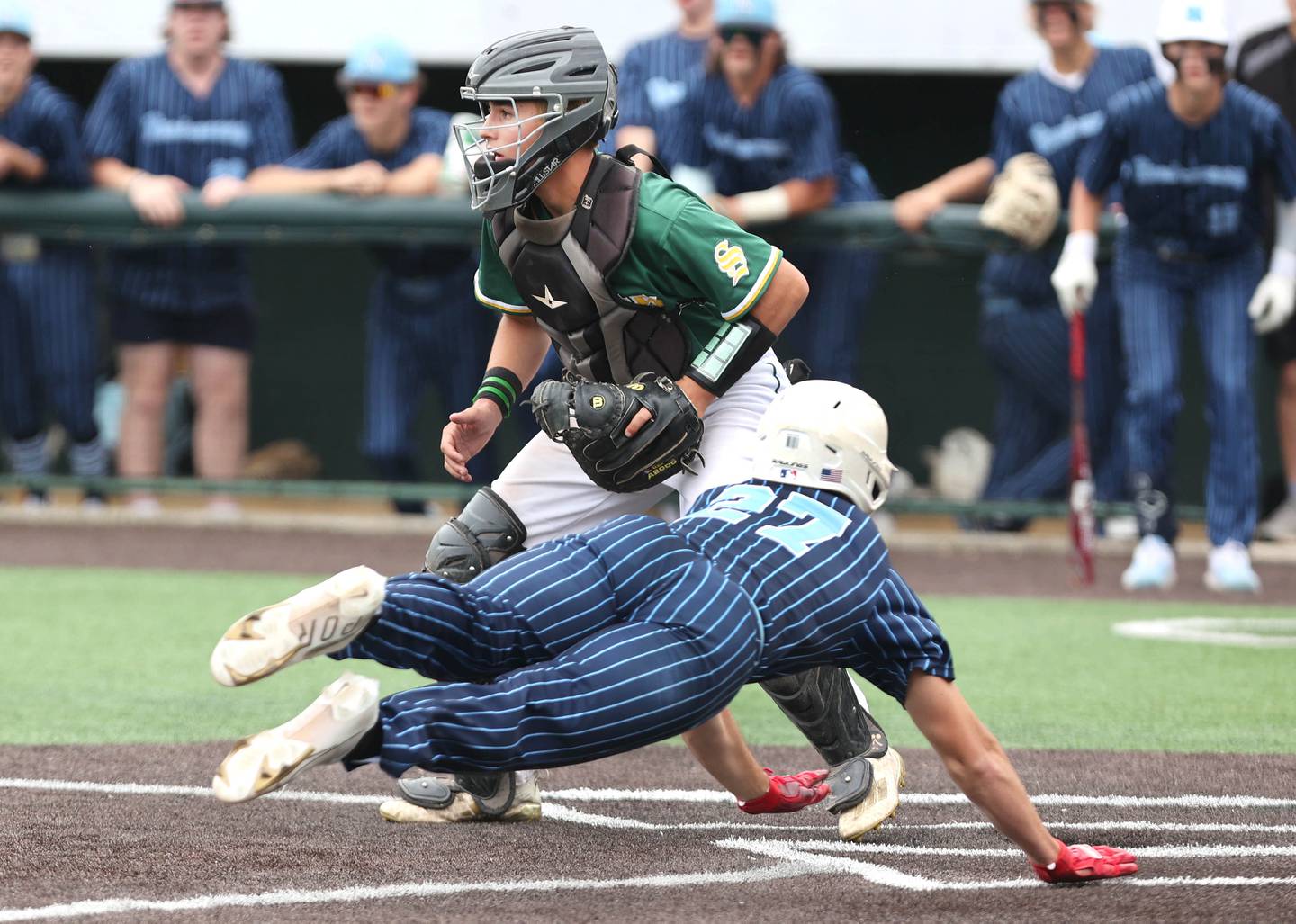 Nazareth's David Cox scores a run as Crystal Lake South's Kyle Kuffel waits for the throw Friday, June 10, 2022, during their IHSA Class 3A state semifinal game at Duly Health and Care Field in Joliet.