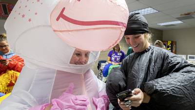 Party time!: Dixon moms don blow-up gear to celebrate their graduating seniors