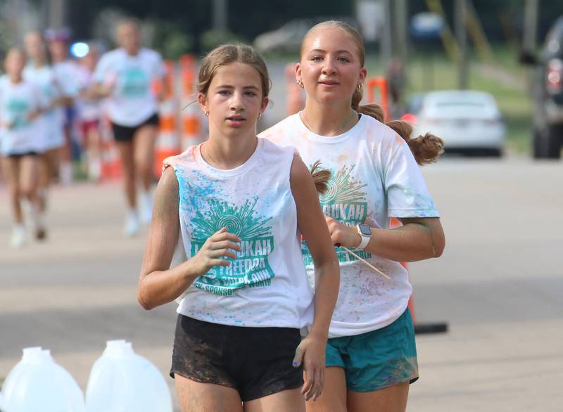 Maycie Munson and Avery May race during the Arukah Institute of Healing Freedom Color Run on Friday, July 4, 2025 at Soldiers and Sailors Park in Princeton.