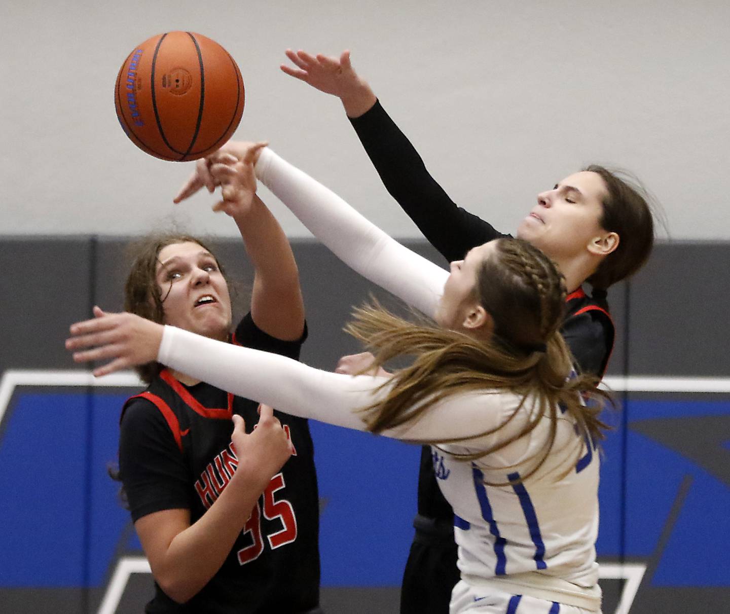 Huntley's Paula Strzelecki (left) and Alyssa Borzych battle with Burlington Central's Emma Payton as the try to recover the basketball during a Fox Valley Conference girls basketball game on Friday, Dec. 15, 2023, at Burlington Central High School.