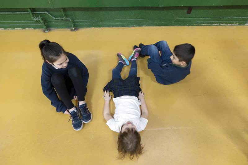 St. Andrew Catholic School students do sit-ups Thursday, Feb. 2, 2023 as part of their “Warm Up with the Saints” activity.