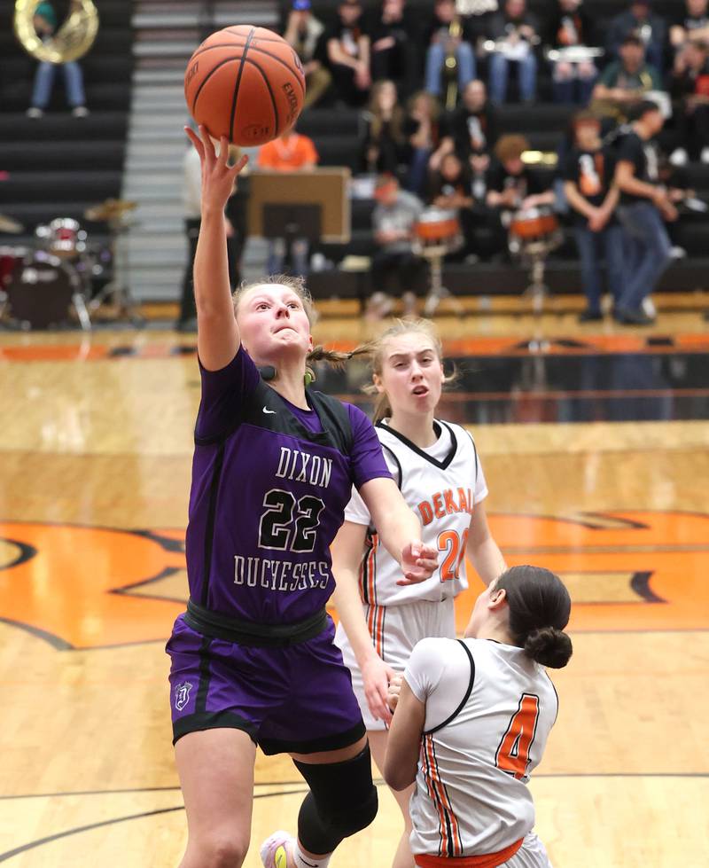 Dixon’s Katie Drew gets a layup over DeKalb’s Ella Medina during their game Monday, Jan. 23, 2023, at DeKalb High School.