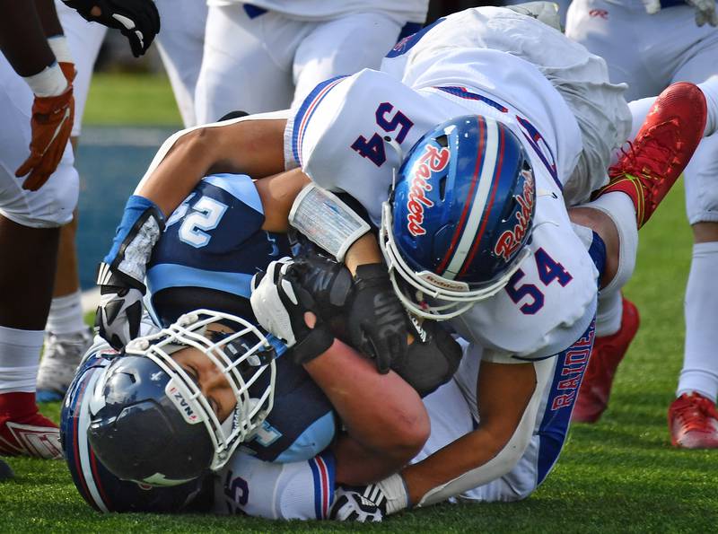 Glenbard South's Ari Ioannou (54) stops Nazareth's Alexander Angulo during a Class 5A second round game on Nov. 4, 2023 at Nazareth Academy in LaGrange Park.